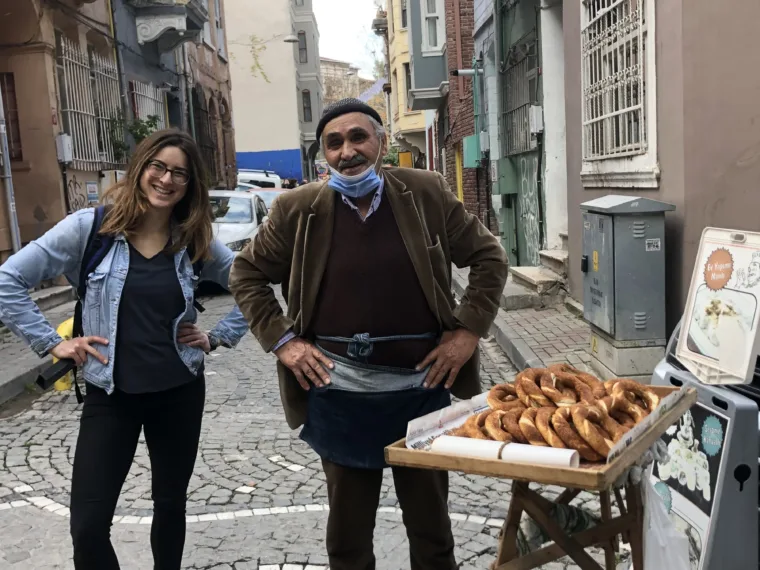 A simit cart on a Balat street with the seller beside it