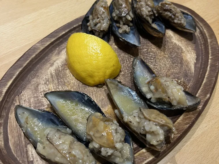 Midye dolma, mussels stuffed with spiced rice, served with lemon