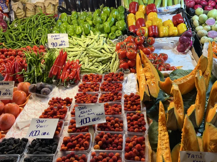 A greengrocer stall of vegetables, cherries and olives at an Istanbul market