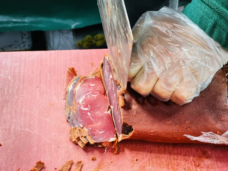 A butcher slicing pastırma to order