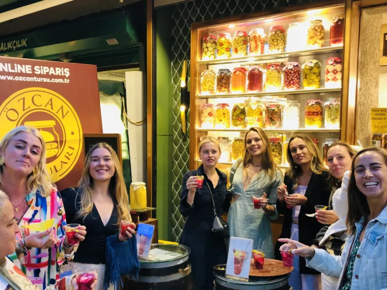 Guests with drinks outside a pickle shop on the Istanbul Evening Food Tour