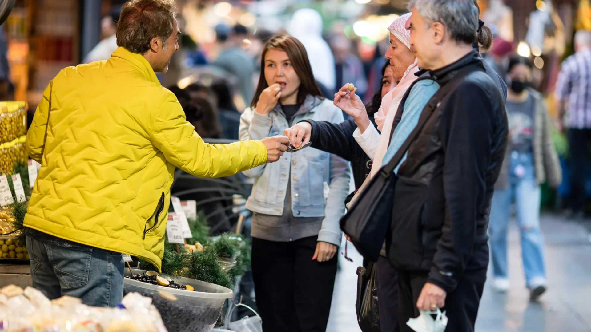 The guide handing round a taste in a busy Istanbul market street