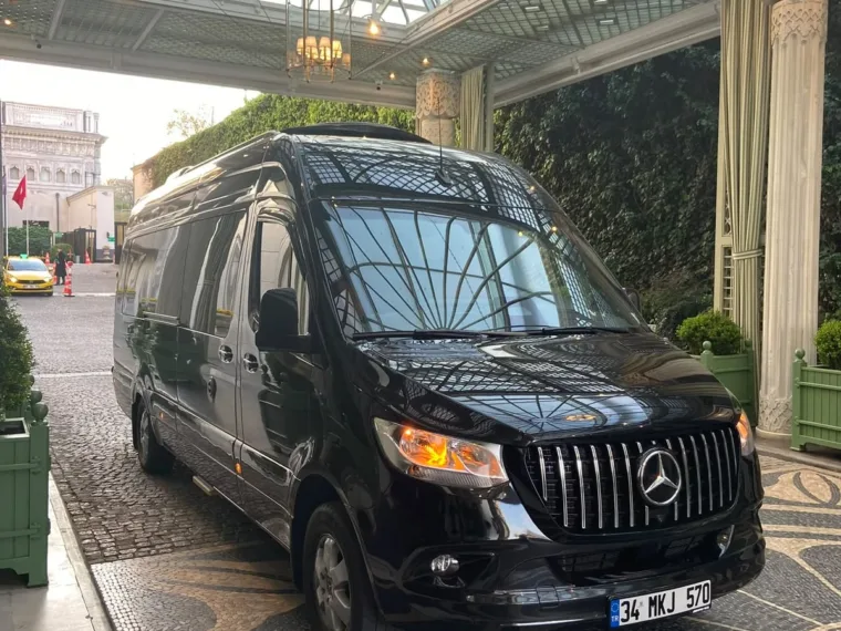 The Mercedes Sprinter used for larger groups, waiting at a hotel entrance