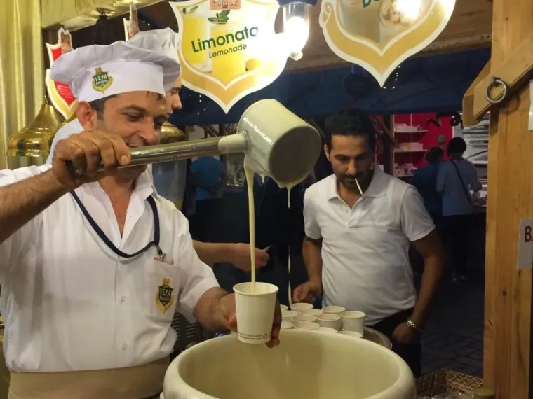 Boza poured from a jug at a boza counter in Istanbul