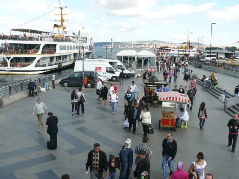 Commuter ferries at Eminönü with crowds crossing the waterfront