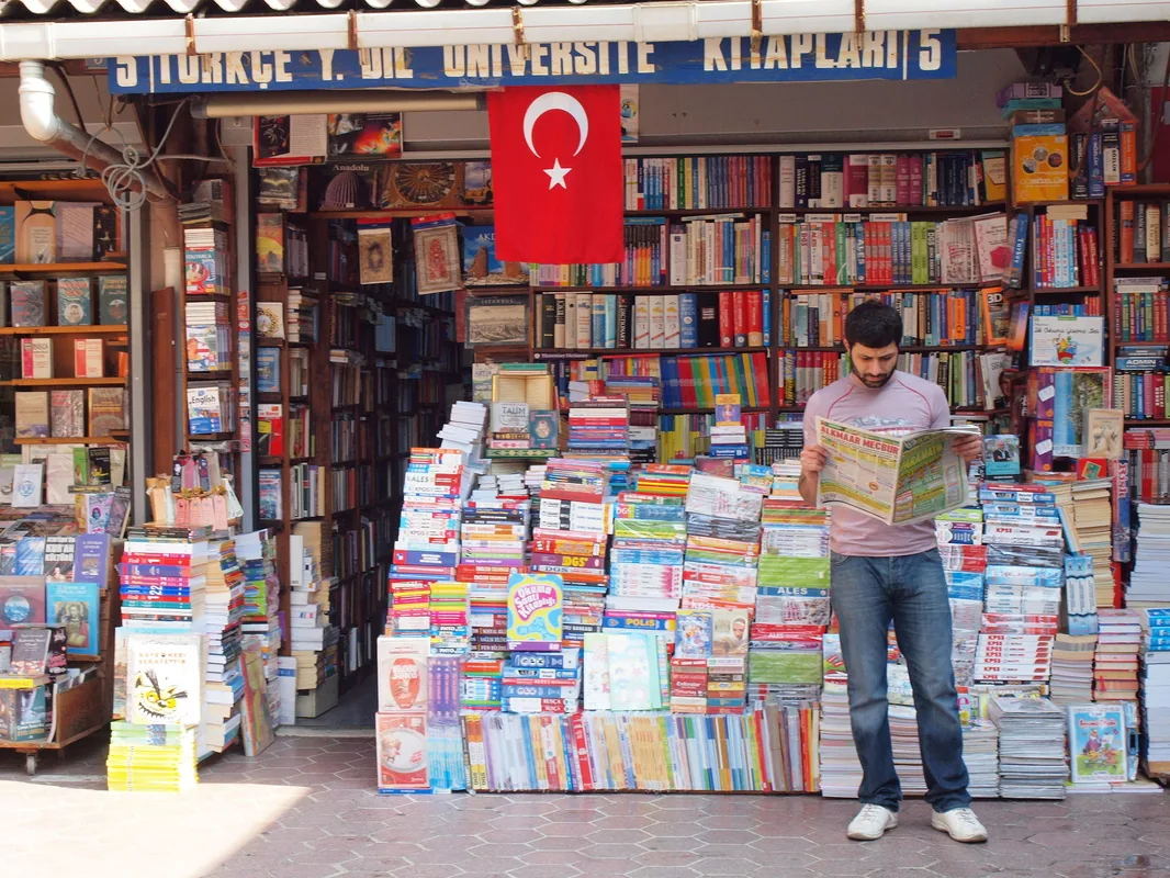 A stall at the Sahaflar book bazaar stacked with maps and guidebooks