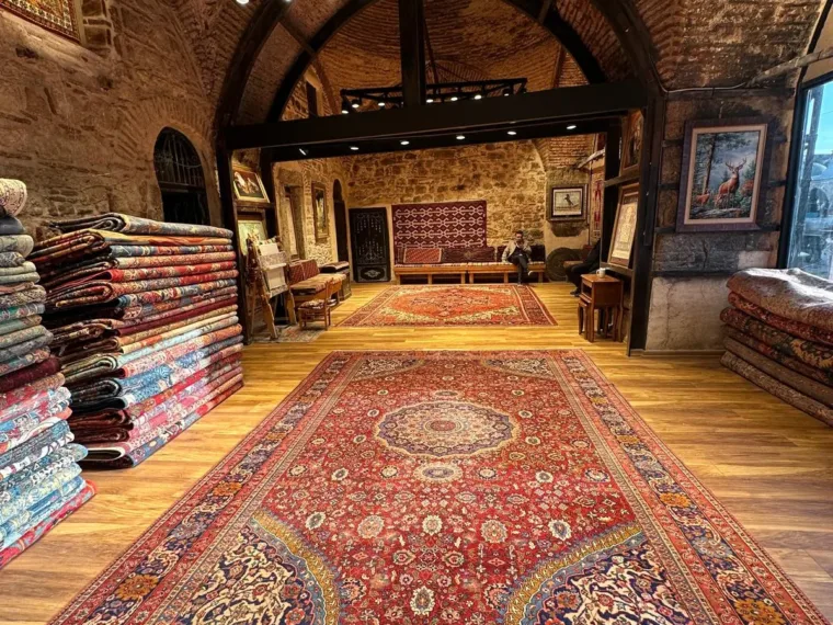 Carpets laid out under the brick vaults of the workshop showroom