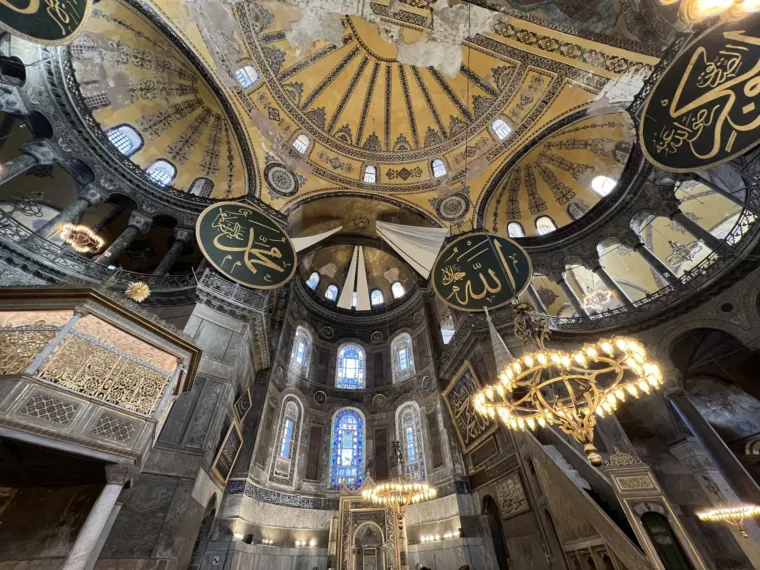 The main dome of Hagia Sophia with its calligraphy roundels and hanging chandeliers