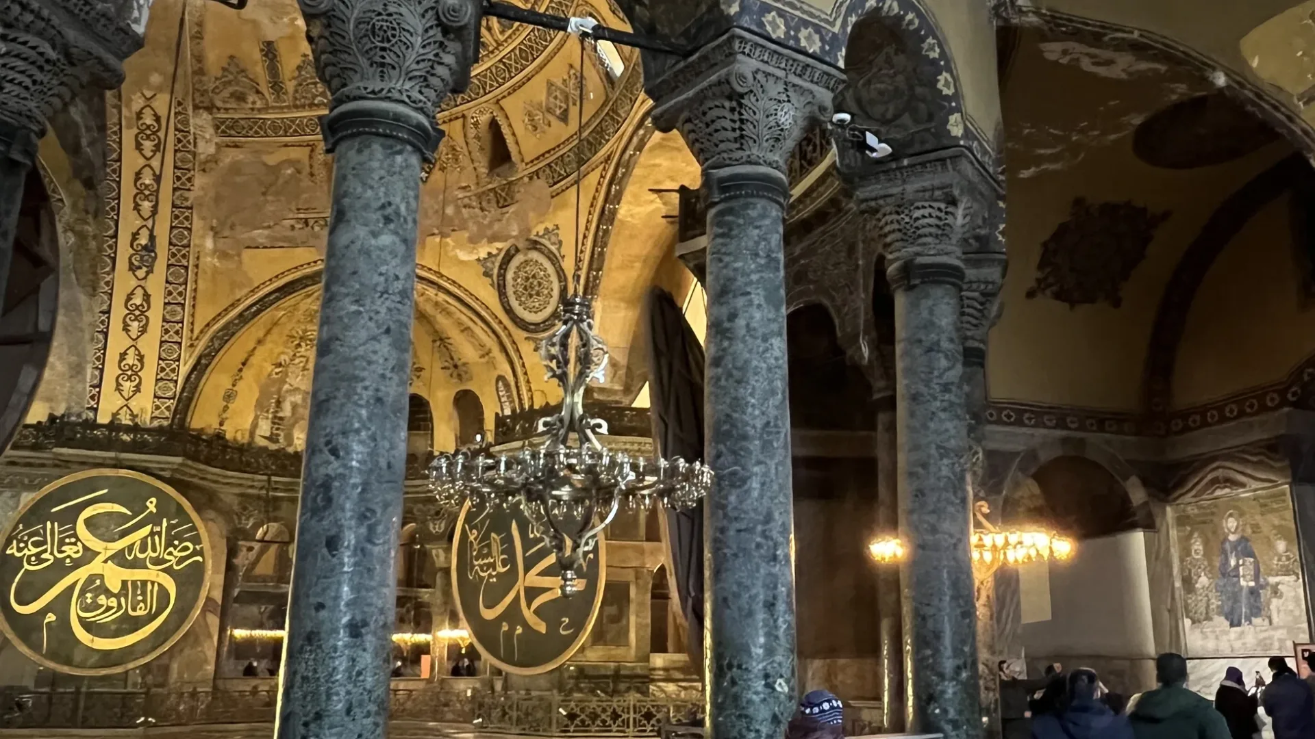 Marble columns and gold calligraphy roundels inside Hagia Sophia