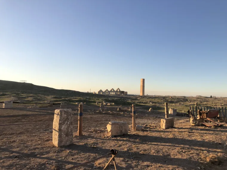 Standing stones and the tower of the old university at Harran at dusk