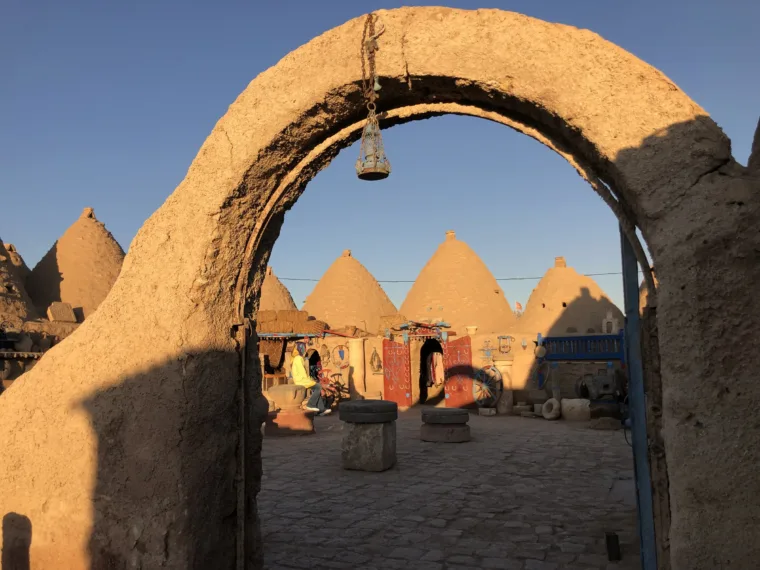 The beehive houses of Harran framed by a mud brick arch