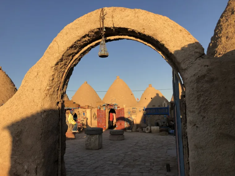 The Harran beehive houses seen through the arch of the courtyard entrance