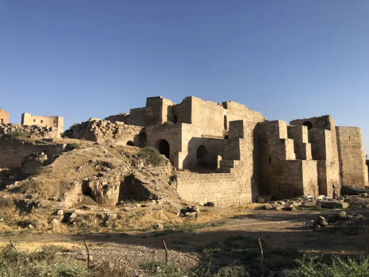 Ruined stone houses and broken walls on a hillside in southeastern Turkey