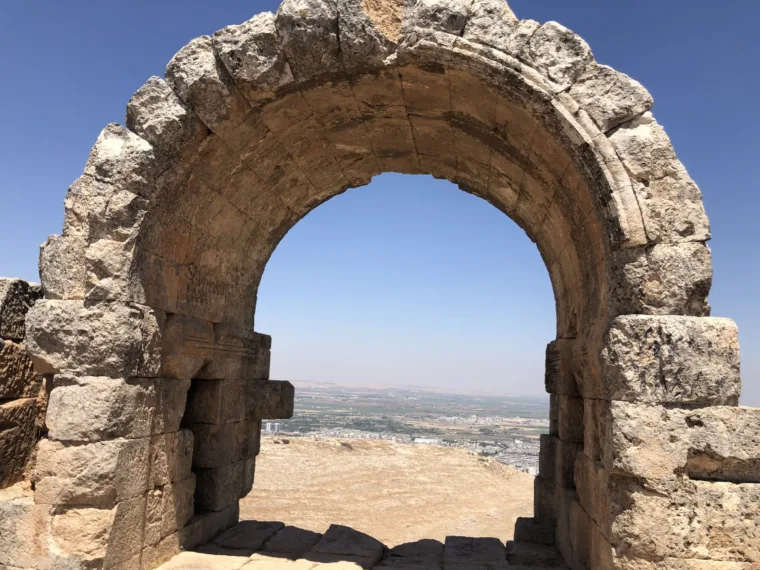 A Roman arch framing the plain below, on the Mesopotamia tour