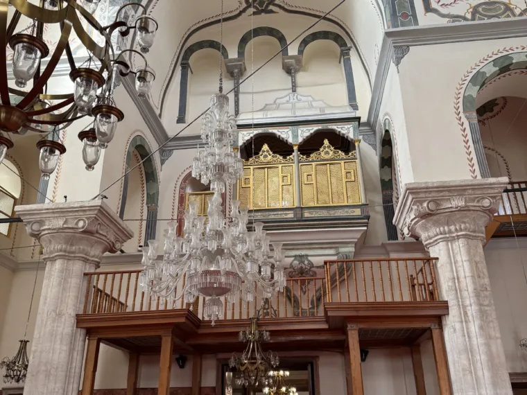 Chandelier and carved wooden gallery inside a working neighbourhood mosque in Istanbul