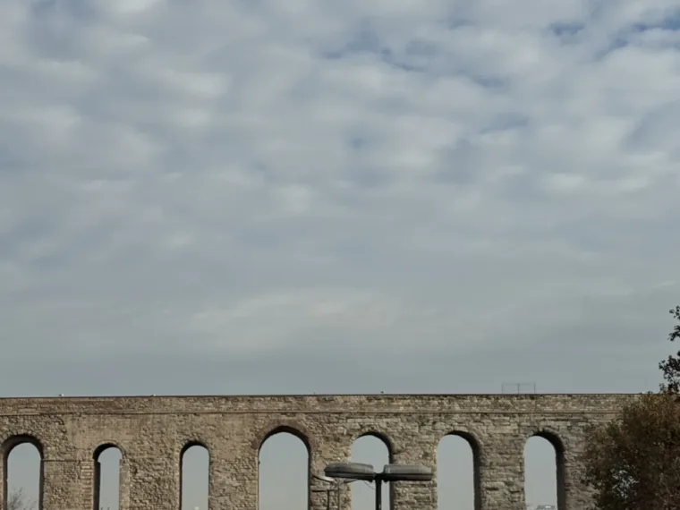 The Aqueduct of Valens rising over the traffic in Istanbul on a cloudy day