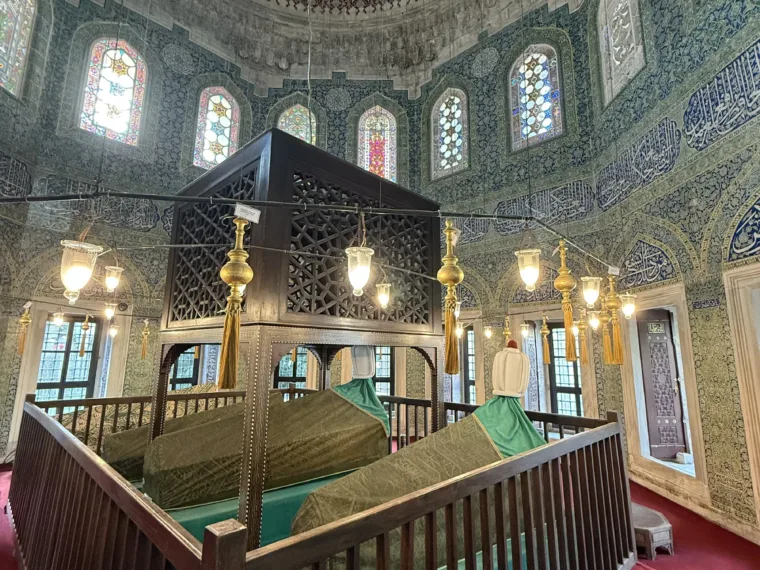 Inside an Ottoman tomb in Istanbul, with its draped catafalques and painted dome