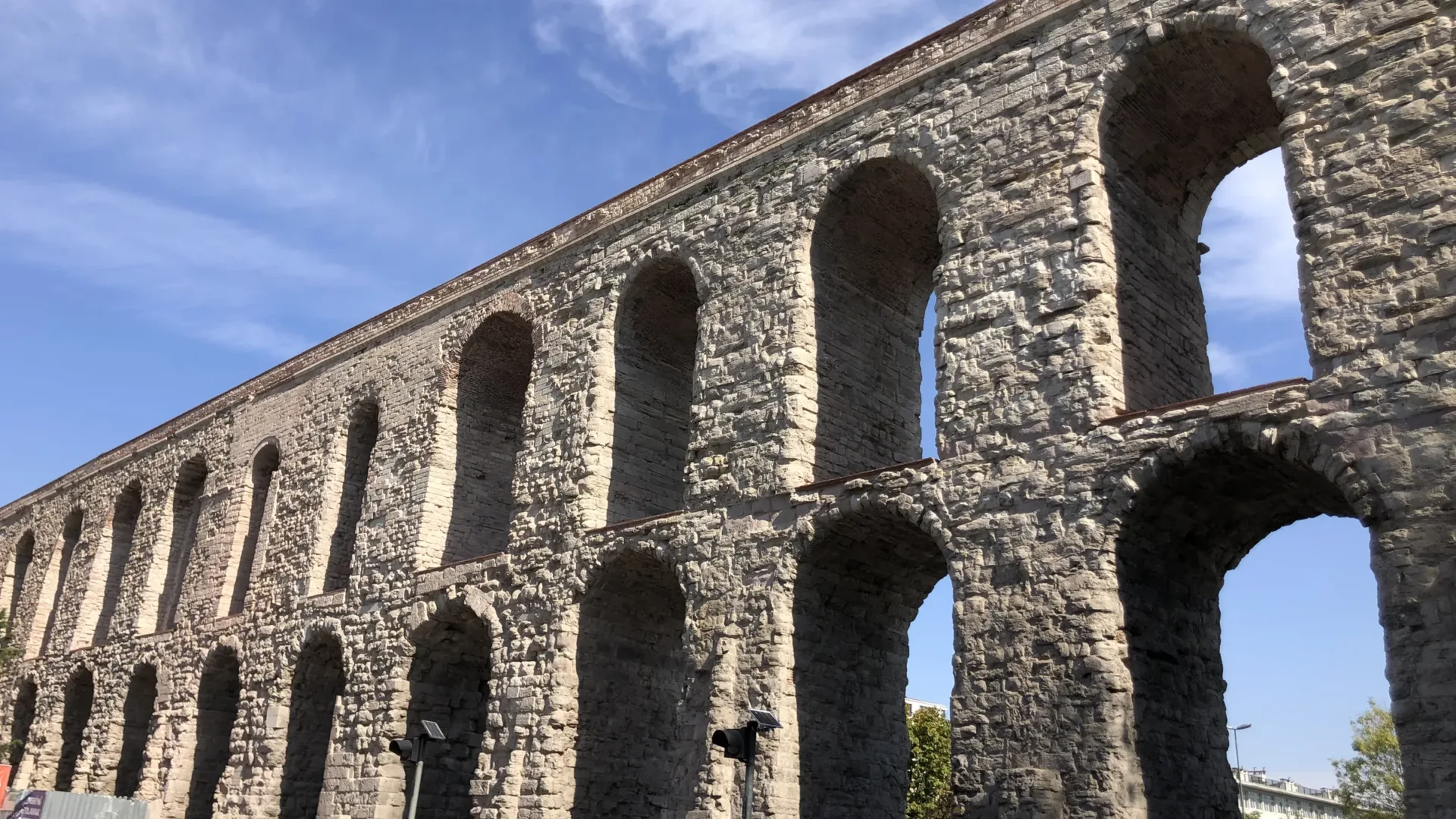 The two tiers of arches of the Aqueduct of Valens in Istanbul against a blue sky