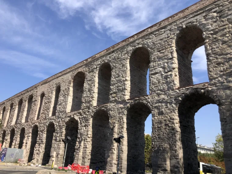 The two tiers of arches of the Aqueduct of Valens in Istanbul against a blue sky