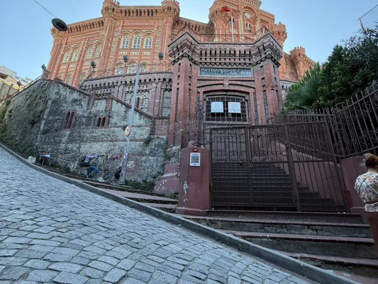 The front of the Phanar Greek Orthodox College in Fener, the red brick school seen up the cobbled street